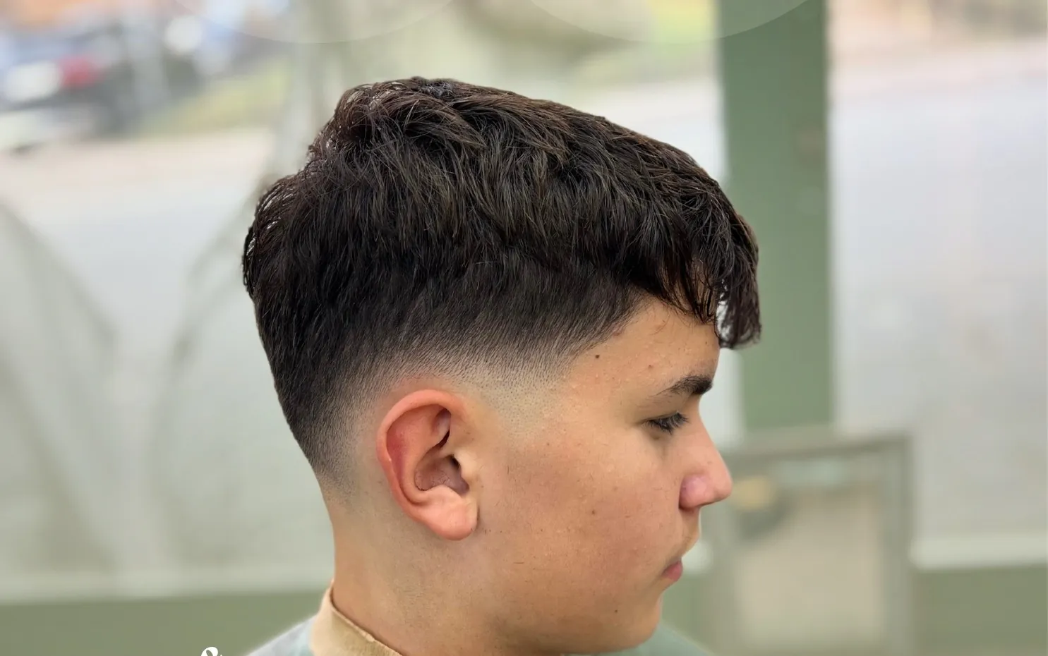 Textured crop with a skin fade, by the street window