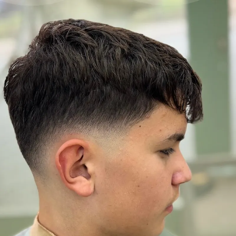 Textured cut with a skin fade, side profile